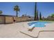 Sparkling pool with a diving board, surrounded by lush greenery for a serene backyard oasis at 727 N Beverly --, Mesa, AZ 85201