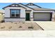 Charming single-story home featuring a desert landscape and a lovely green front door at 8437 W Clemente Way, Florence, AZ 85132