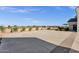 Expansive backyard with a concrete patio and decorative brick border, surrounded by lush landscaping and serene ambiance at 856 W Quail Cir, San Tan Valley, AZ 85143