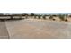 Expansive concrete patio and desert-style landscaping blend harmoniously, offering a versatile outdoor area for relaxation and recreation at 856 W Quail Cir, San Tan Valley, AZ 85143