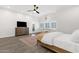 Serene bedroom features a ceiling fan, shuttered windows, and neutral-toned decor at 856 W Quail Cir, San Tan Valley, AZ 85143