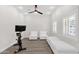 Bright bonus room with comfortable seating and a modern ceiling fan at 856 W Quail Cir, San Tan Valley, AZ 85143