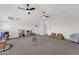 Large bonus room with bright, neutral-toned interiors, dual ceiling fans, and playroom and play areas at 856 W Quail Cir, San Tan Valley, AZ 85143