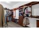 Spacious walk-in closet with custom built-in shelving and window bench seating at 856 W Quail Cir, San Tan Valley, AZ 85143