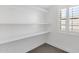 Spacious closet with white shelves and a window letting in natural light at 856 W Quail Cir, San Tan Valley, AZ 85143