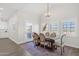 Light-filled dining room showcases a vaulted ceiling, wood table, and neutral decor at 856 W Quail Cir, San Tan Valley, AZ 85143