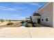 Exterior home view showcasing beautiful landscaping, mature trees, gravel, and paved driveway, blending beauty and convenience at 856 W Quail Cir, San Tan Valley, AZ 85143