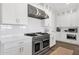 Chef's kitchen with stainless steel range and custom white cabinetry at 856 W Quail Cir, San Tan Valley, AZ 85143