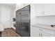 Bright kitchen features stainless steel refrigerator, white cabinets, and wood-look flooring at 856 W Quail Cir, San Tan Valley, AZ 85143