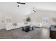 Cozy living room with ceiling fans, neutral decor, and plush sofas at 856 W Quail Cir, San Tan Valley, AZ 85143
