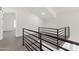 Upstairs landing featuring a modern staircase with black railings and neutral carpeting at 856 W Quail Cir, San Tan Valley, AZ 85143