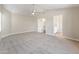 Spacious bedroom features neutral carpet, vaulted ceiling, ceiling fan, and access to hallway and bathroom at 1073 N 159Th Dr, Goodyear, AZ 85338