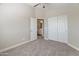 Bedroom with neutral walls and carpet features closet and access to bathroom at 1073 N 159Th Dr, Goodyear, AZ 85338
