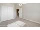 Bright bedroom has neutral walls, carpet, closet and view into hall at 1073 N 159Th Dr, Goodyear, AZ 85338