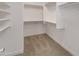 Walk-in closet with neutral carpet and white storage shelves and rack at 1073 N 159Th Dr, Goodyear, AZ 85338