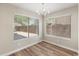Bright dining area with wood floors and natural light, featuring two large windows at 1073 N 159Th Dr, Goodyear, AZ 85338