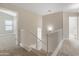 Bright hallway features neutral walls and carpet, plus white stair railing and access to bedrooms at 1073 N 159Th Dr, Goodyear, AZ 85338