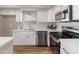 Stylish kitchen boasts stainless steel appliances, white cabinetry, and plenty of counter space at 1073 N 159Th Dr, Goodyear, AZ 85338