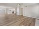 Spacious living room featuring wood-look floors and an open staircase to upper level at 1073 N 159Th Dr, Goodyear, AZ 85338