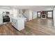 Spacious open-concept view with kitchen island, staircase and a cozy fireplace at 1073 N 159Th Dr, Goodyear, AZ 85338