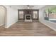 Well-lit living room with wood-look floors and a cozy fireplace at 1073 N 159Th Dr, Goodyear, AZ 85338