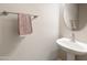 Elegant powder room featuring a pedestal sink and stylish faucet at 1073 N 159Th Dr, Goodyear, AZ 85338