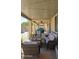 Covered patio with wicker furniture and string lights, perfect for entertaining or relaxation at 1075 E Crimm Rd, San Tan Valley, AZ 85143