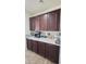 Coffee bar area showcasing dark wood cabinets, bright countertops, and subway tile backsplash at 1075 E Crimm Rd, San Tan Valley, AZ 85143