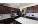 Modern kitchen with stainless steel appliances, dark cabinetry, and a bright quartz island at 1075 E Crimm Rd, San Tan Valley, AZ 85143