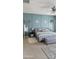 This main bedroom features an accent wall, bedside tables, decor shelves, an upholstered bench, and an area rug at 1075 E Crimm Rd, San Tan Valley, AZ 85143