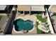 Aerial view of the backyard featuring a uniquely shaped pool, turf, and shaded patio areas at 1075 E Crimm Rd, San Tan Valley, AZ 85143