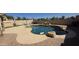 Beautiful pool featuring stone accents and a textured concrete patio for outdoor enjoyment at 1075 E Crimm Rd, San Tan Valley, AZ 85143