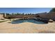 Backyard pool with a charming rock waterfall and easy access to outdoor relaxation areas at 1075 E Crimm Rd, San Tan Valley, AZ 85143