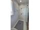 This is a close-up of a bright white marble shower enclosure with glass doors and a rainfall shower head at 1075 E Crimm Rd, San Tan Valley, AZ 85143