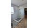 This bright shower features marble walls, a frameless glass door, a rain shower head, and a bench outside the shower at 1075 E Crimm Rd, San Tan Valley, AZ 85143