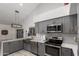 Modern kitchen featuring gray cabinetry, stainless steel appliances, and bright countertops at 10830 N 11Th St, Phoenix, AZ 85020