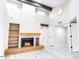 Bright living room showcasing wood beam accents, fireplace and direct access to bedrooms at 10830 N 11Th St, Phoenix, AZ 85020