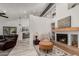 Bright living room with vaulted ceilings, modern fireplace, and seamless flow into the kitchen at 10830 N 11Th St, Phoenix, AZ 85020