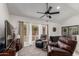 Comfortable living room featuring ample natural light, ceiling fan, and leather recliners at 10830 N 11Th St, Phoenix, AZ 85020
