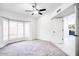 Bright, spacious main bedroom with a ceiling fan, plush carpet, and natural light at 10830 N 11Th St, Phoenix, AZ 85020
