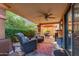 Relaxing covered patio with ceiling fan, outdoor furniture, and views of the landscaped backyard at 10830 N 11Th St, Phoenix, AZ 85020