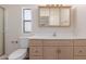 Bathroom featuring a vanity with storage cabinets and a toilet, designed for functionality at 11275 N 99Th Ave # 1, Peoria, AZ 85345