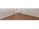 Bright bedroom with wood-look flooring features white walls and doors at 11275 N 99Th Ave # 1, Peoria, AZ 85345