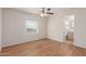 Bedroom with wood floors, a window for natural light, and an attached bathroom for convenience at 11275 N 99Th Ave # 1, Peoria, AZ 85345