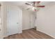 Bright bedroom with wood-look flooring features white walls and doors, and ceiling fan at 11275 N 99Th Ave # 1, Peoria, AZ 85345