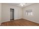 Bedroom with wood-look floors features window with blinds and sliding door closet at 11275 N 99Th Ave # 1, Peoria, AZ 85345