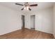 The bedroom has wood floors, a ceiling fan, and a closet for storage at 11275 N 99Th Ave # 1, Peoria, AZ 85345