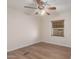 Bright bedroom with a ceiling fan, wood-look flooring and a window with wooden blinds at 11275 N 99Th Ave # 1, Peoria, AZ 85345