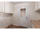 Mud room features lots of cabinets, door to outside, and wood look flooring at 11275 N 99Th Ave # 1, Peoria, AZ 85345