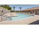 Community pool area featuring an inground pool, hot tub, lounge chairs, and covered pergola at 11275 N 99Th Ave # 1, Peoria, AZ 85345